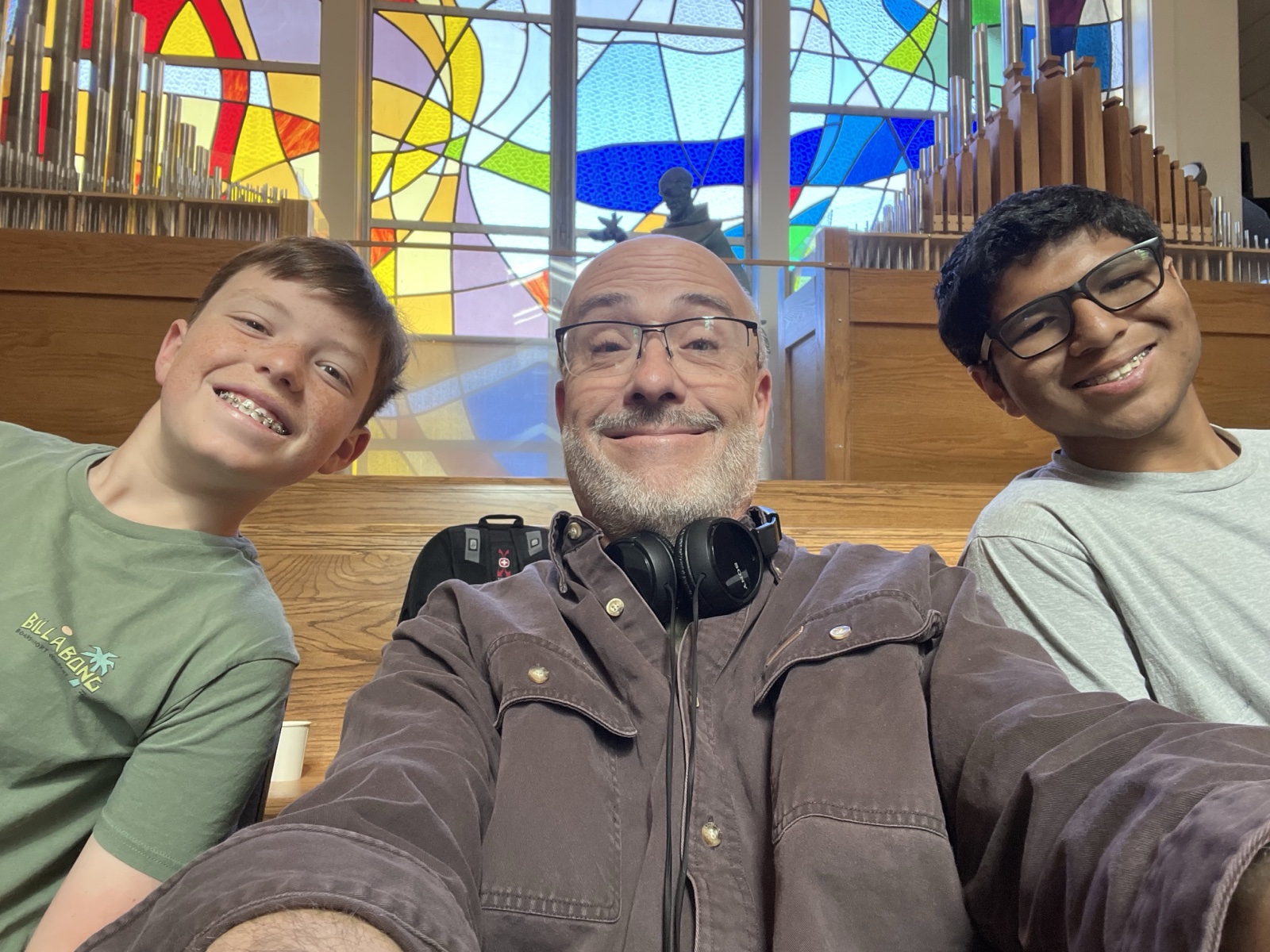 Jim with two students between Masses